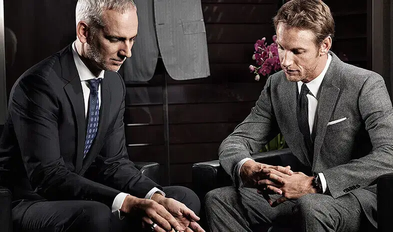 An image of a custom suit tailor and a client