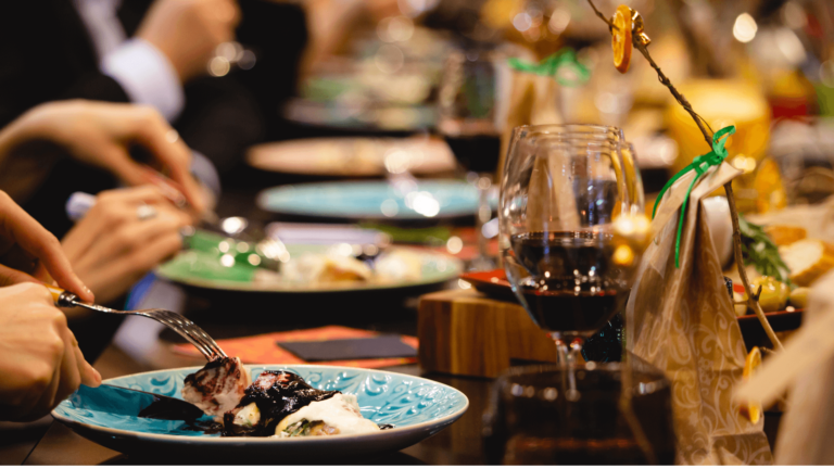 an image of a cozy restaurants setting with a smartphone on the table displaying the Potoru website.